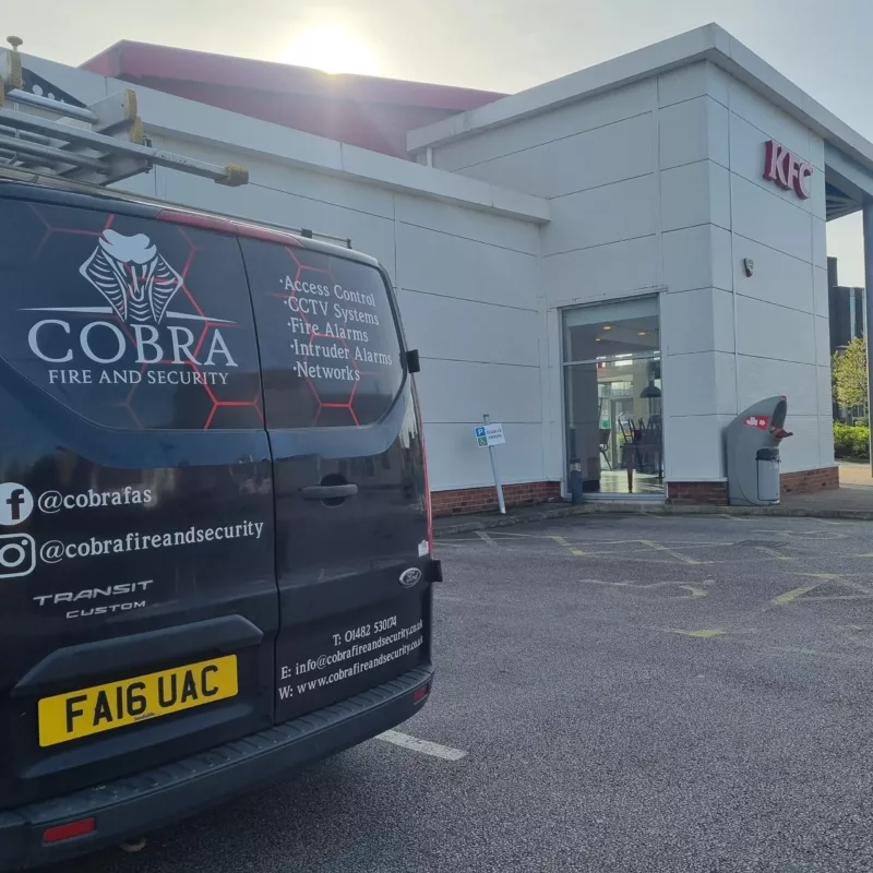 Van Cobra Fire and Security Van parked outside in a carpark for KFC